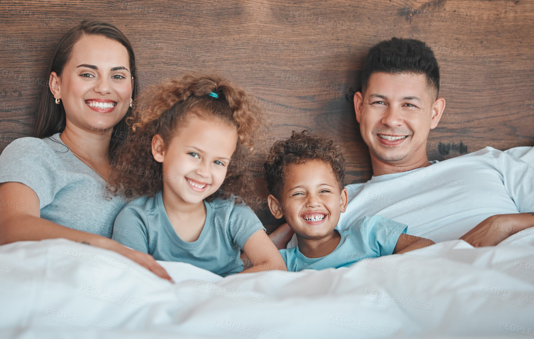 Buy stock photo Shot of a young family spending time together at home