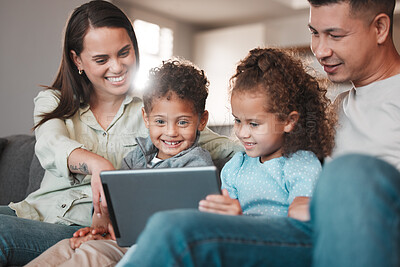 Buy stock photo Shot of a young family using a digital tablet together at home