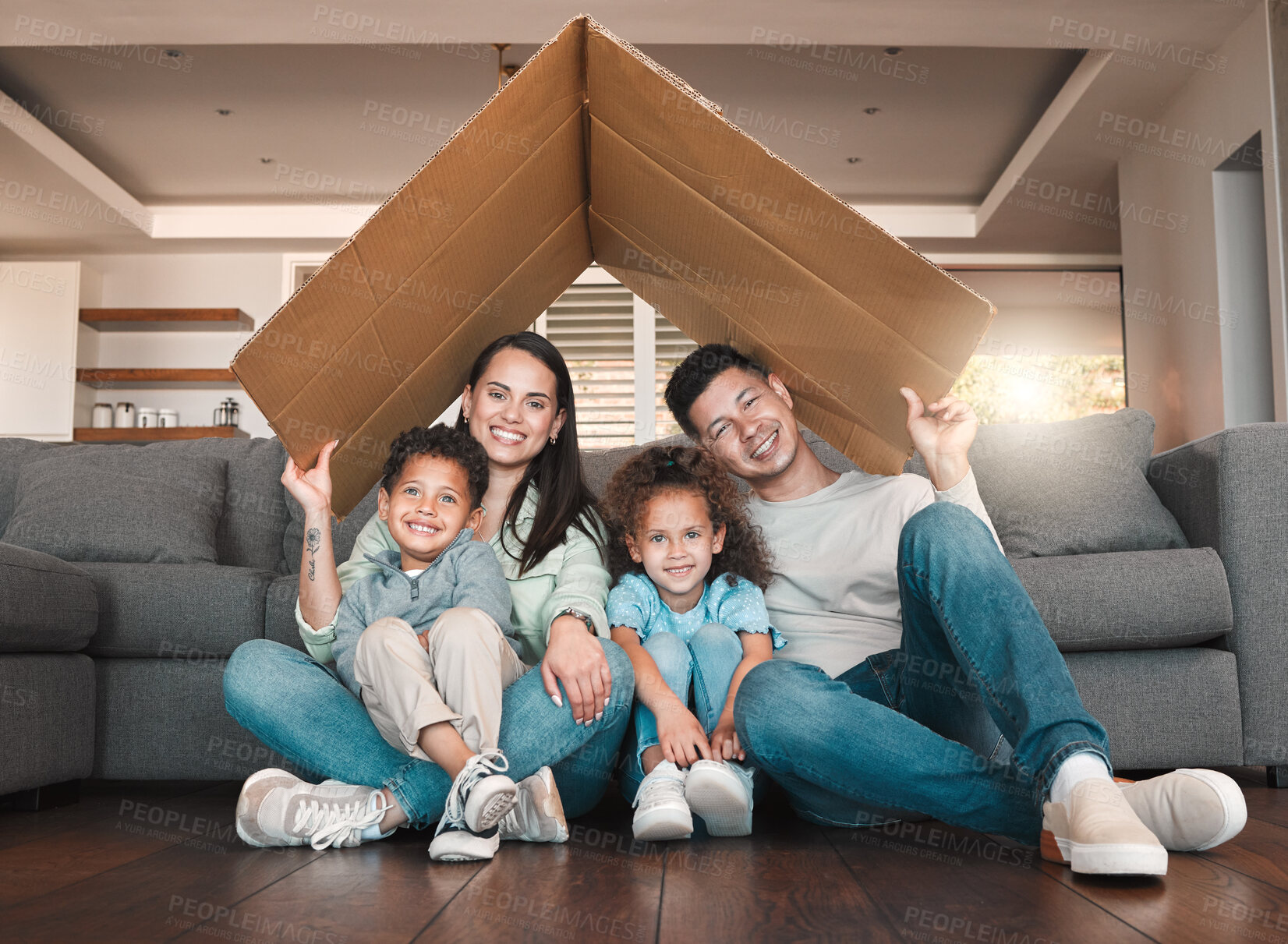 Buy stock photo Shot of a young family spending time together at home