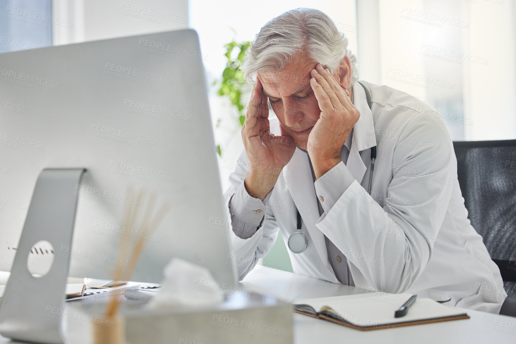 Buy stock photo Mature man, doctor and headache from burnout, overworked or anxiety at office. Stressed male medical professional, computer and eye strain for report, research and health solution issue in workplace