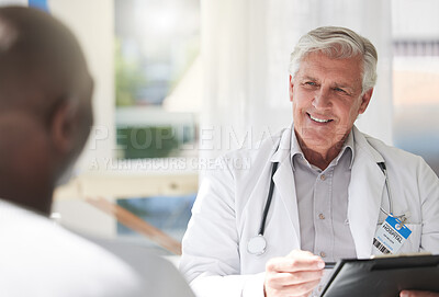 Buy stock photo Shot of a mature doctor having a checkup with a patient at a hospital