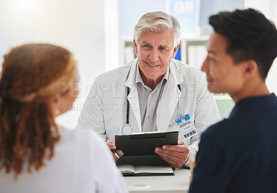 Buy stock photo Gynecologist, couple and smile for results, good news and medical clinic info for IVF treatment wellness. Mature man, discussion and people happy for feedback report, notes or health communication