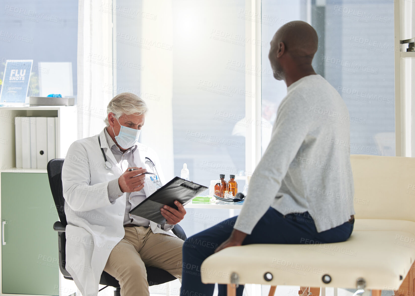 Buy stock photo Shot of a mature doctor having a checkup with a patient at a hospital