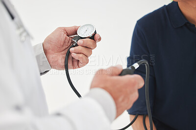 Buy stock photo Shot of an unrecognizable doctor monitoring a patient's blood pressure at a hospital