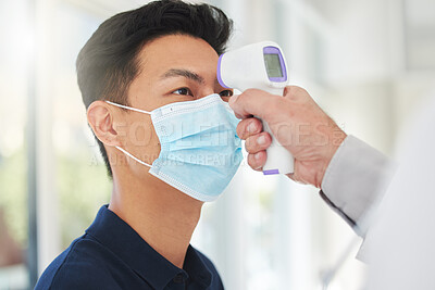 Buy stock photo Shot of an unrecognizable doctor taking a patient's temperature at a hospital