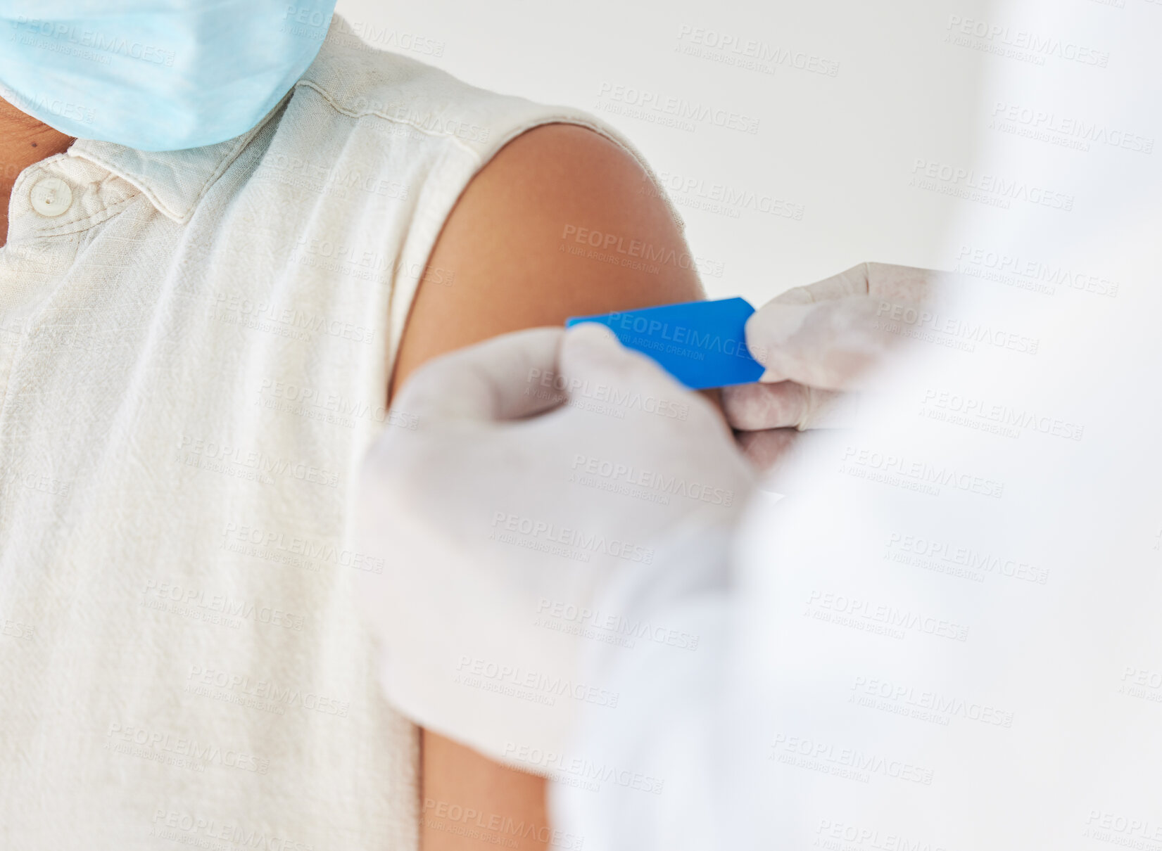 Buy stock photo Clinic, doctor and arm of person with bandage in injection for healthcare, support and virus protection. Medical, ppe and gloves with band aid in consultation for mpox vaccine, immunization or safety