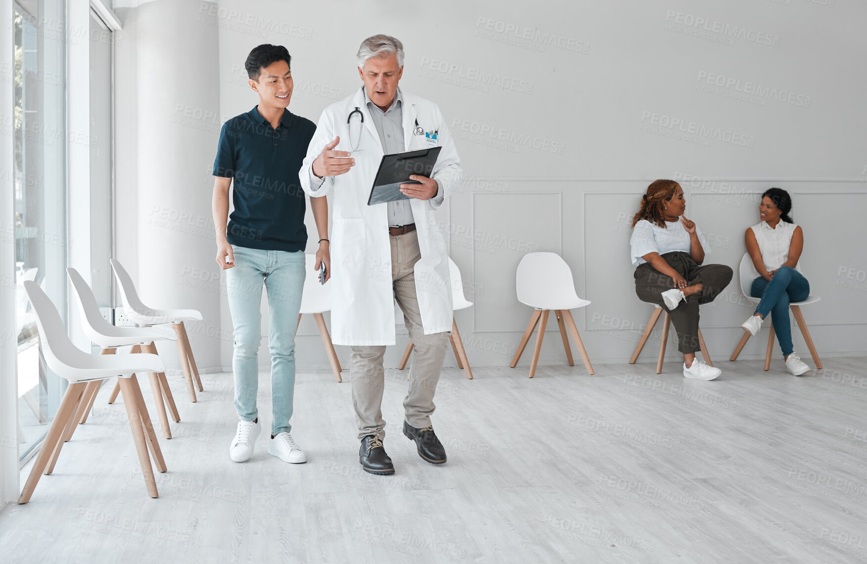 Buy stock photo Appointment, hospital or medical with doctor and patient in waiting room for checkup, feedback or insurance. Conversation, documents or healthcare with medicine professional talking to client man