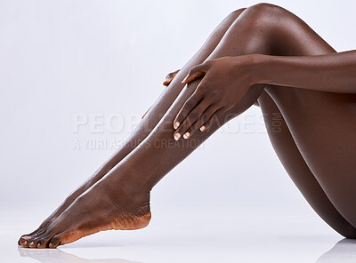 Buy stock photo Skincare, legs and black person in studio for hair removal, epilation and smooth skin on white background. Body, woman and hands touching with manicure for wellness, waxing and moisturize for beauty