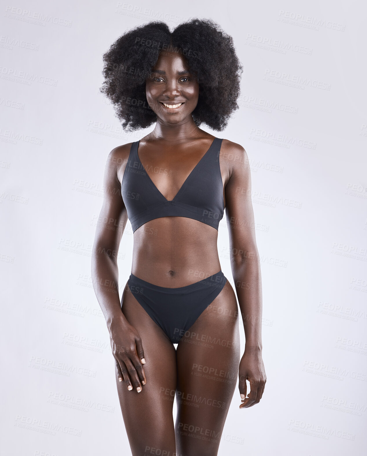 Buy stock photo Shot of a young woman posing in her underwear against a studio background