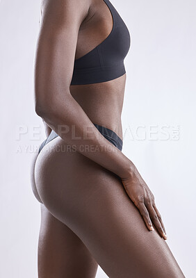 Buy stock photo Cropped shot of a woman showing off her body against a studio background