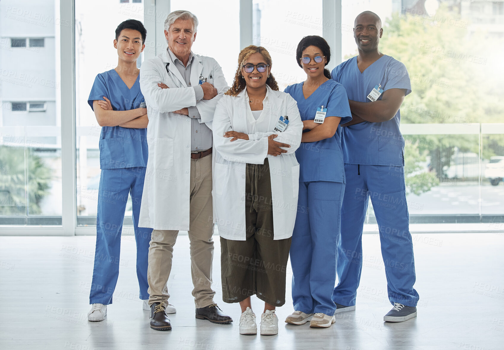 Buy stock photo Leadership portrait, doctors and nurses with arms crossed standing together in hospital. Face, teamwork and confident medical professionals, group or happy surgeons with collaboration for healthcare