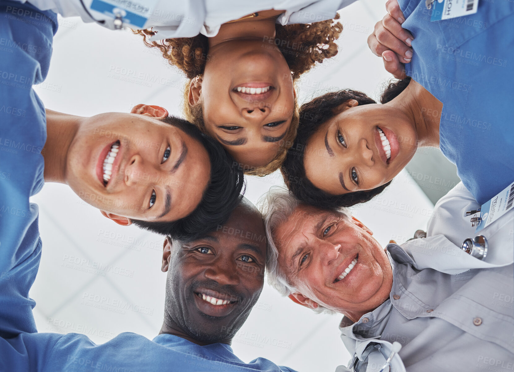 Buy stock photo Below, portrait or doctors in circle for healthcare, professional or pride with diversity in hospital. Medical specialist, surgery or team with smile for synergy, collaboration or trust in solidarity