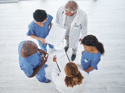 Buy stock photo High angle shot of a group of medical practitioners having a discussion together in a hospital