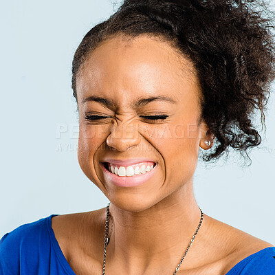 Buy stock photo Shot of an attractive young woman standing alone in the studio and laughing