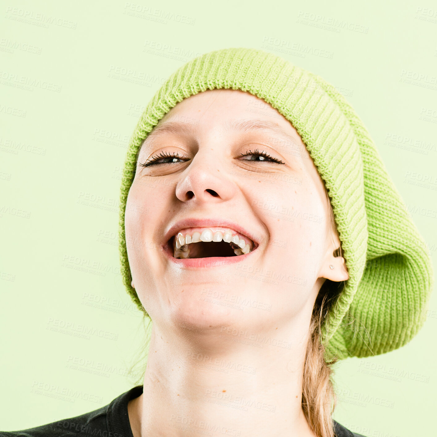 Buy stock photo Laugh, hat and portrait of woman on green background with stylish, trendy accessory and winter clothes. Happy, smile and face of isolated person with beanie in studio for confidence, pride and cool