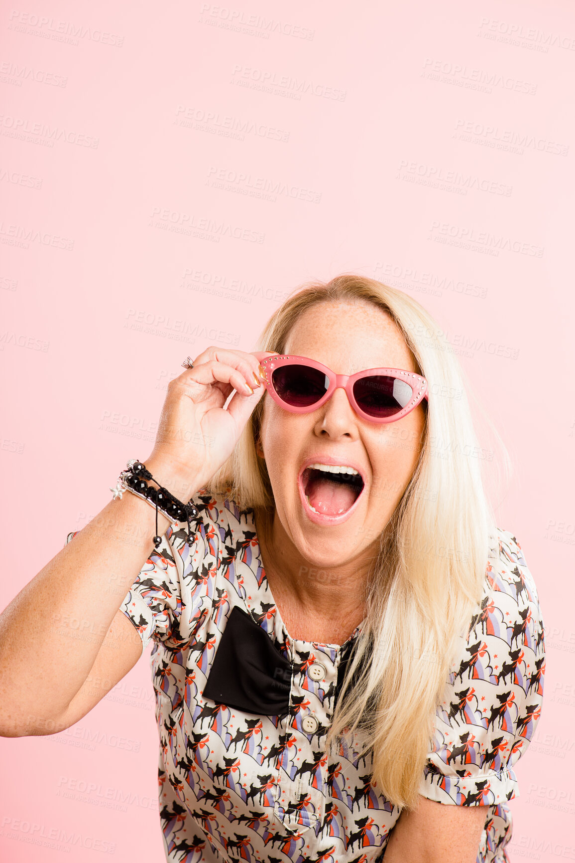 Buy stock photo Excited, sunglasses and face of woman in studio with confidence, trendy style and cool accessories. Shout, aesthetic and portrait of person with eyewear for sale, deal and fashion on pink background