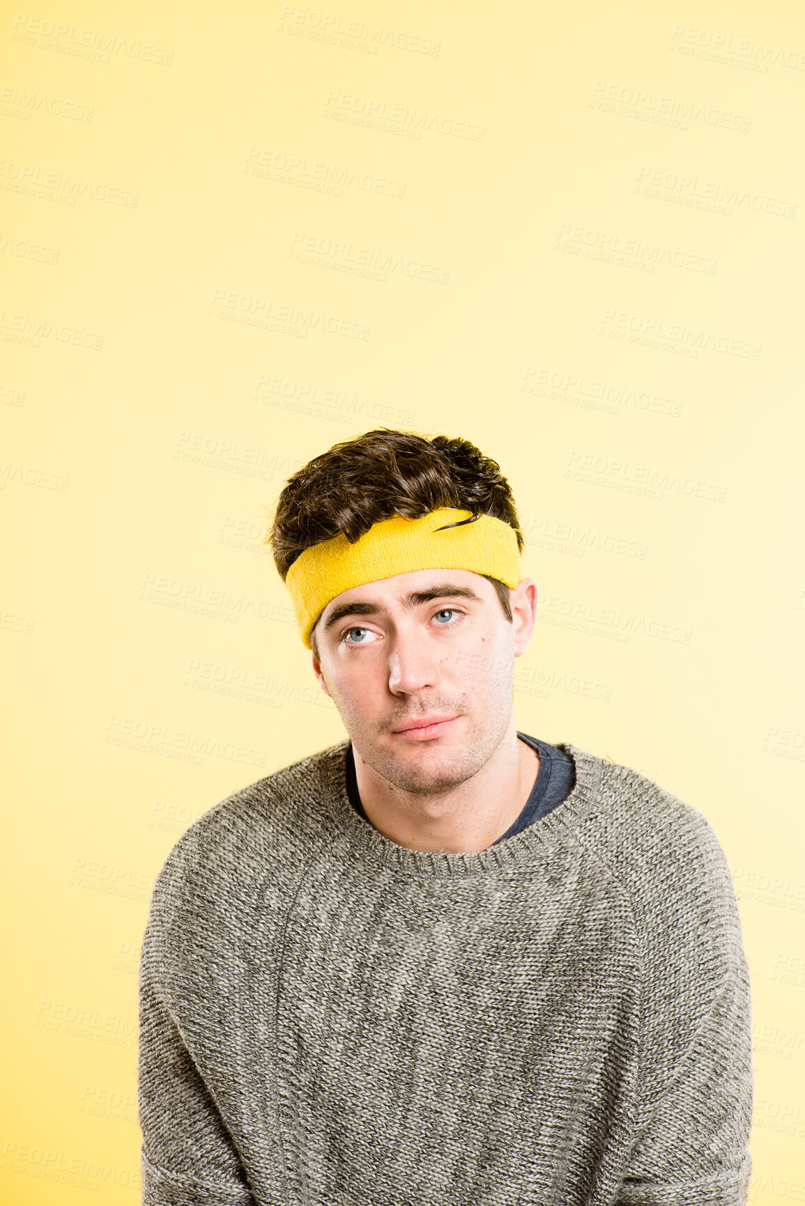 Buy stock photo Bored man, headband and face with hair, thinking or lazy expression on a yellow studio background. Young, male person or tired model with emotion or sweatband on forehead for style on mockup space