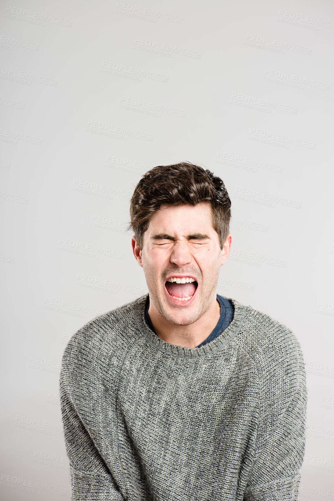 Buy stock photo Shouting, screaming and face of man in studio with anger, upset and crazy reaction. Body language, facial expression and isolated person with loud noise, voice and announcement on gray background