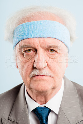 Buy stock photo Shot of a senior man standing alone in the studio and posing while wearing a headband