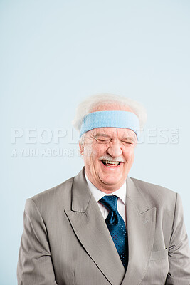 Buy stock photo Shot of a senior man sitting alone in the studio and laughing
