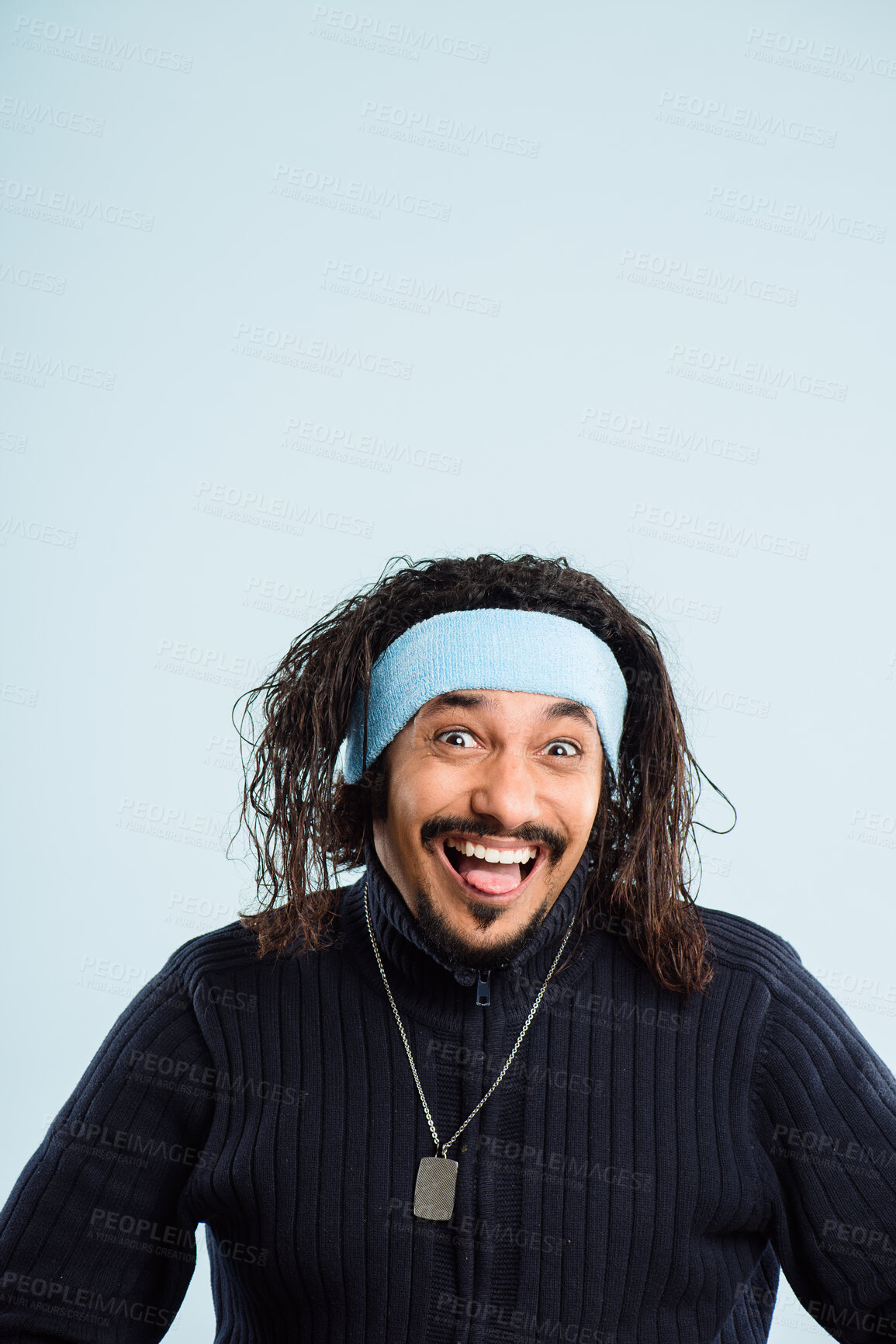 Buy stock photo Studio, portrait and man with tongue out for silly, goofy and funny face with expression for humor. Male person, playful and mockup space by blue background for emoji reaction, character and headband