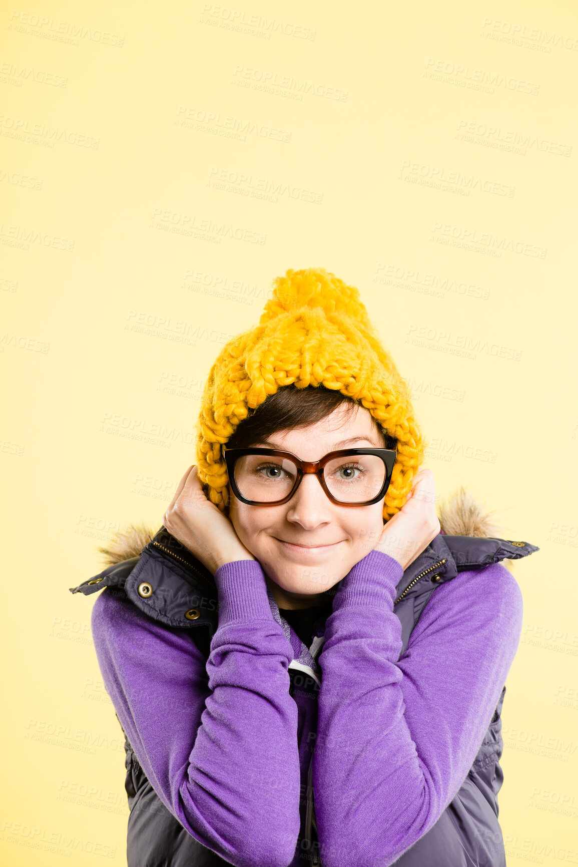 Buy stock photo Glasses, hat and portrait of woman on yellow background with stylish, trendy accessory and winter clothes. Happy, smile and face of isolated person with beanie for confidence, pride or cute in studio