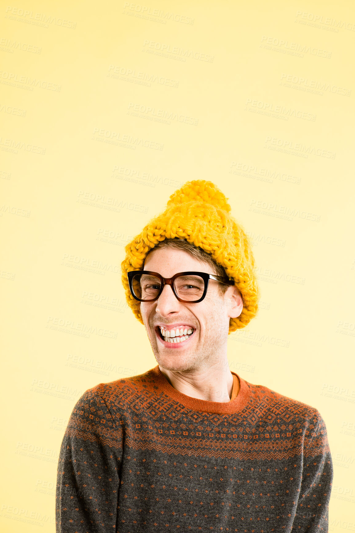 Buy stock photo Man, glasses and wool beanie in studio portrait with smile, mockup space and pride with fashion by background. Person, nerd or geek with cap, excited or quirky style for winter with clothes in France
