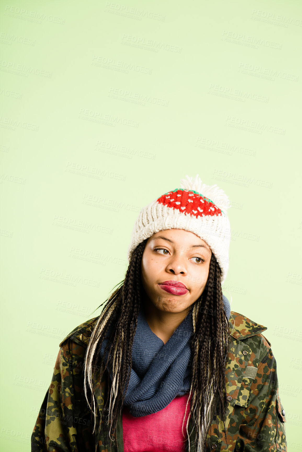 Buy stock photo Bored, black woman and beanie for thinking of fashion in studio, winter weather and warm clothes cold morning. Lonely, African girl and knitted hat for stylish aesthetic, trendy and green background