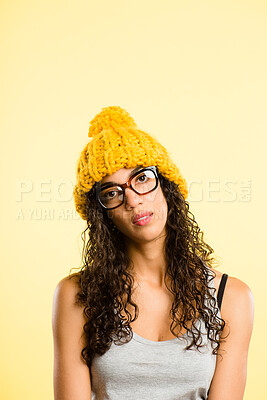 Buy stock photo Portrait, woman and bored with beanie for fashion, winter weather and warm clothes cold morning. Lonely, African girl and knitted hat for stylish aesthetic, trendy glasses and studio background