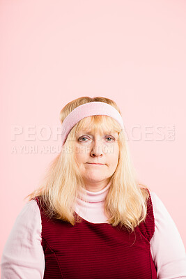 Buy stock photo Shot of an attractive mature woman sitting alone in the studio and posing while wearing a headband