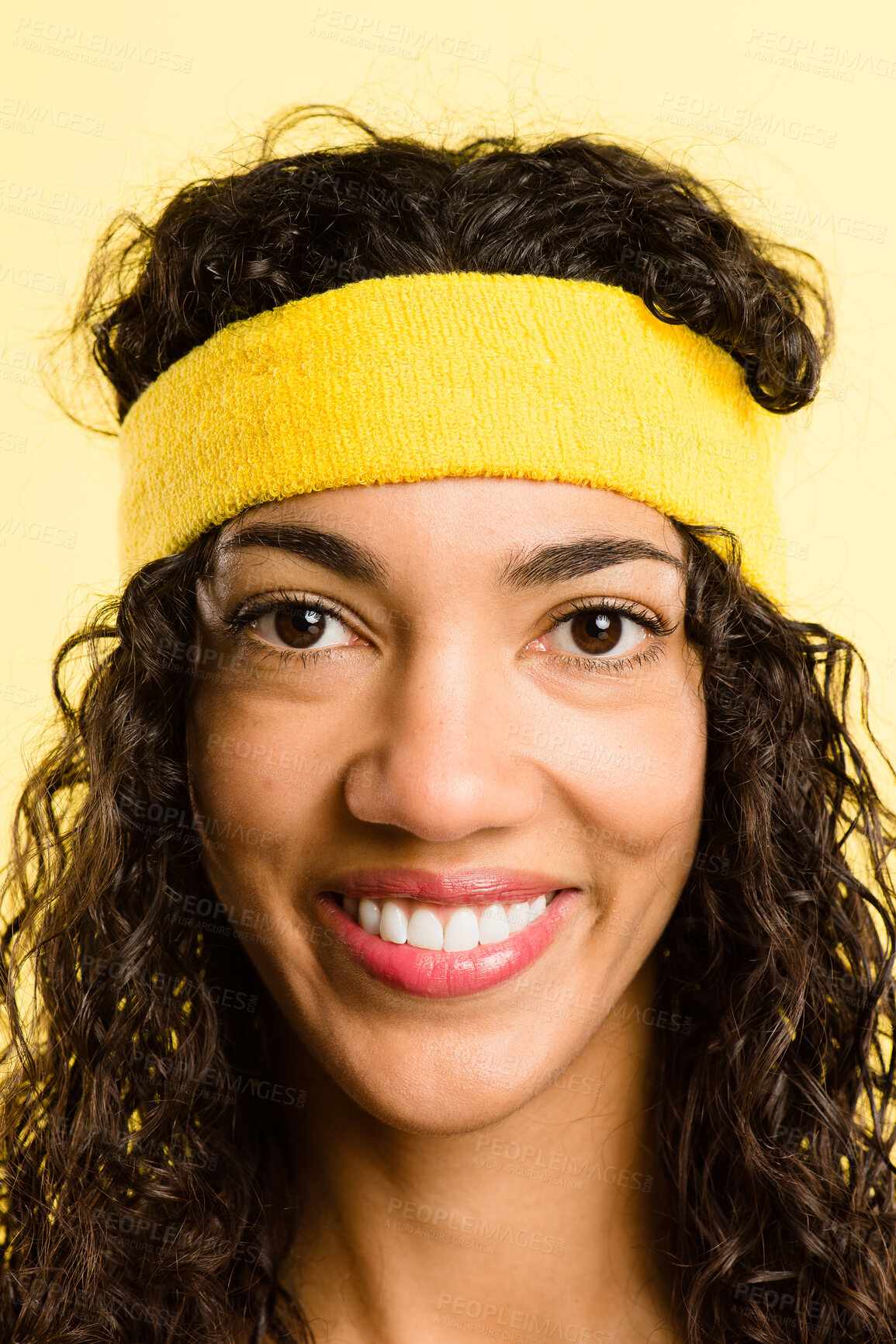 Buy stock photo Shot of an attractive young woman standing alone in the studio and posing while wearing a headband