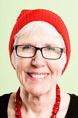 Buy stock photo Shot of a senior woman standing alone in the studio and posing while wearing a beanie and glasses