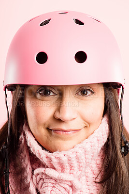 Buy stock photo Shot of a mature woman standing alone in the studio and wearing a helmet
