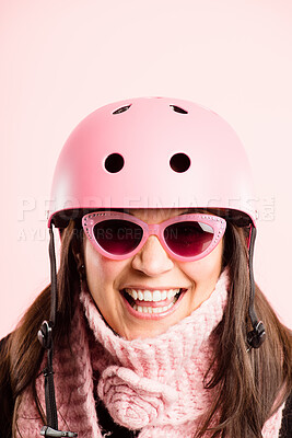 Buy stock photo Shot of a mature woman standing alone in the studio while wearing sunglasses and a helmet