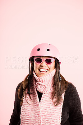 Buy stock photo Woman, studio and happy with sunglasses on helmet for transportation and riding bicycle on pink background. Laughing, fashion and smile or satisfied with safety gear for bike or cycling in style