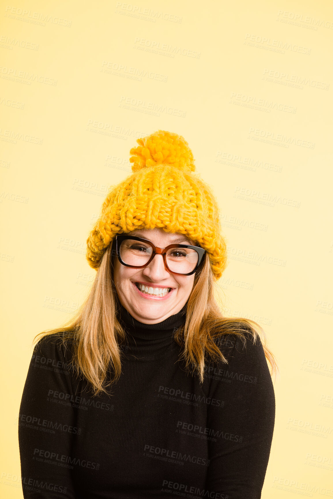 Buy stock photo Portrait, beanie and girl with smile, glasses and confident person on yellow studio background. Face, woman and model with eyewear, excited or winter clothes with happiness and cheerful with fashion