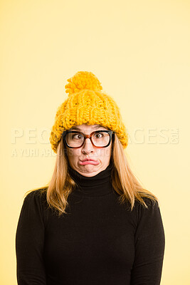 Buy stock photo Goofy, woman and beanie for portrait of fashion, winter weather and warm clothes cold morning. Silly, girl and knitted hat for stylish aesthetic, trendy glasses and crazy comedy on studio background
