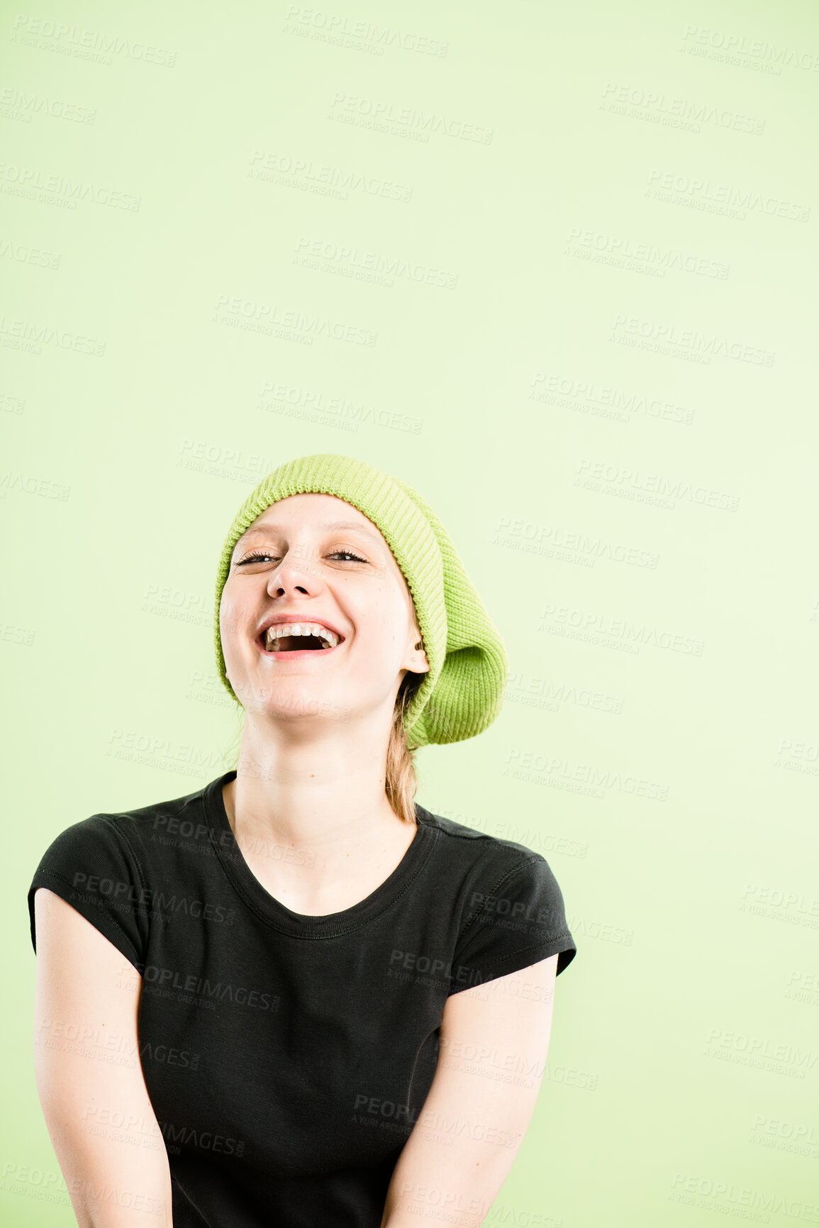 Buy stock photo Laugh, cap and portrait of woman on green background with stylish, trendy accessory and winter hat. Happy, mockup and face of isolated person with beanie in studio for confidence, pride and smile