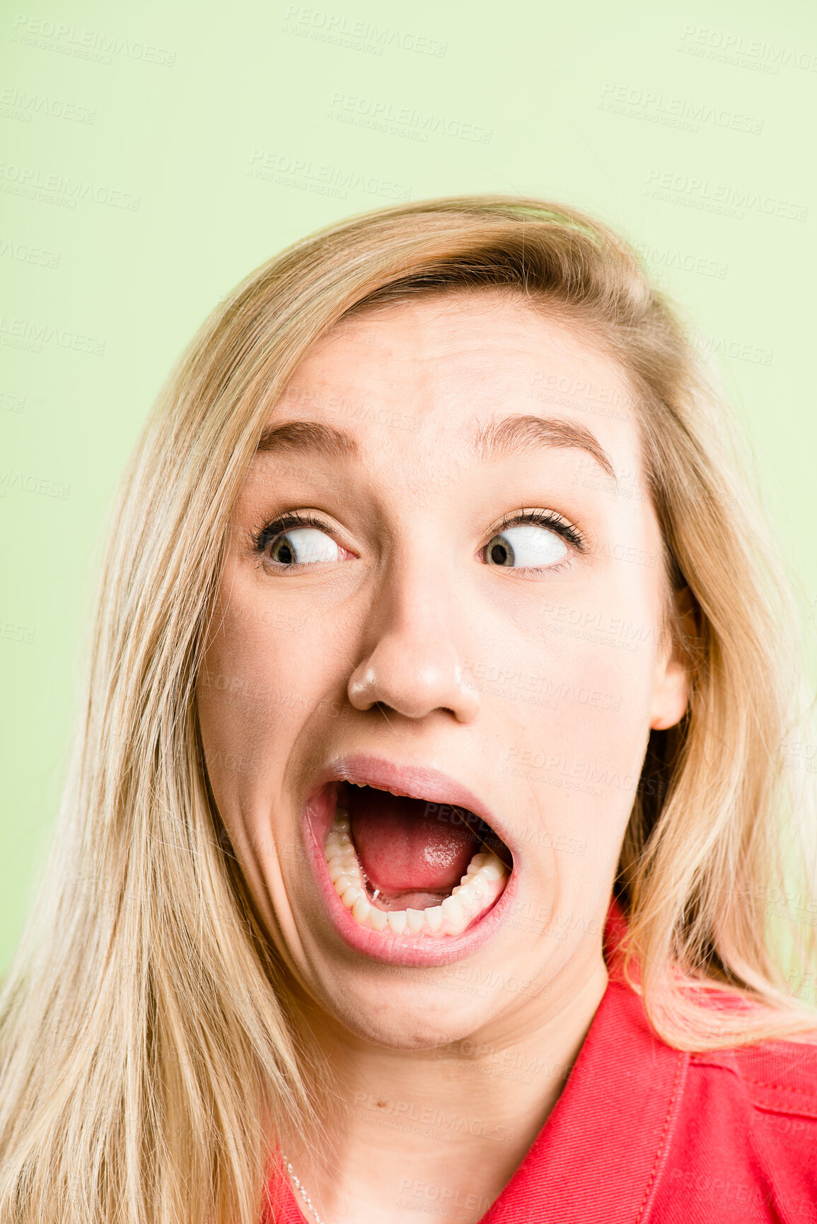 Buy stock photo Woman, surprise and funny face with goofy expression for humor or comedy in studio on a green background. Closeup, female person or silly model in shock with open mouth for comedian comic or fun joke