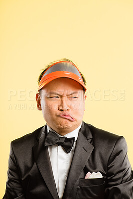 Buy stock photo Funny, face and Asian man in studio space with mockup, comedy and retro gambling aesthetic style. Dealer, crazy and person with goofy attitude, creative and casino fashion on yellow background