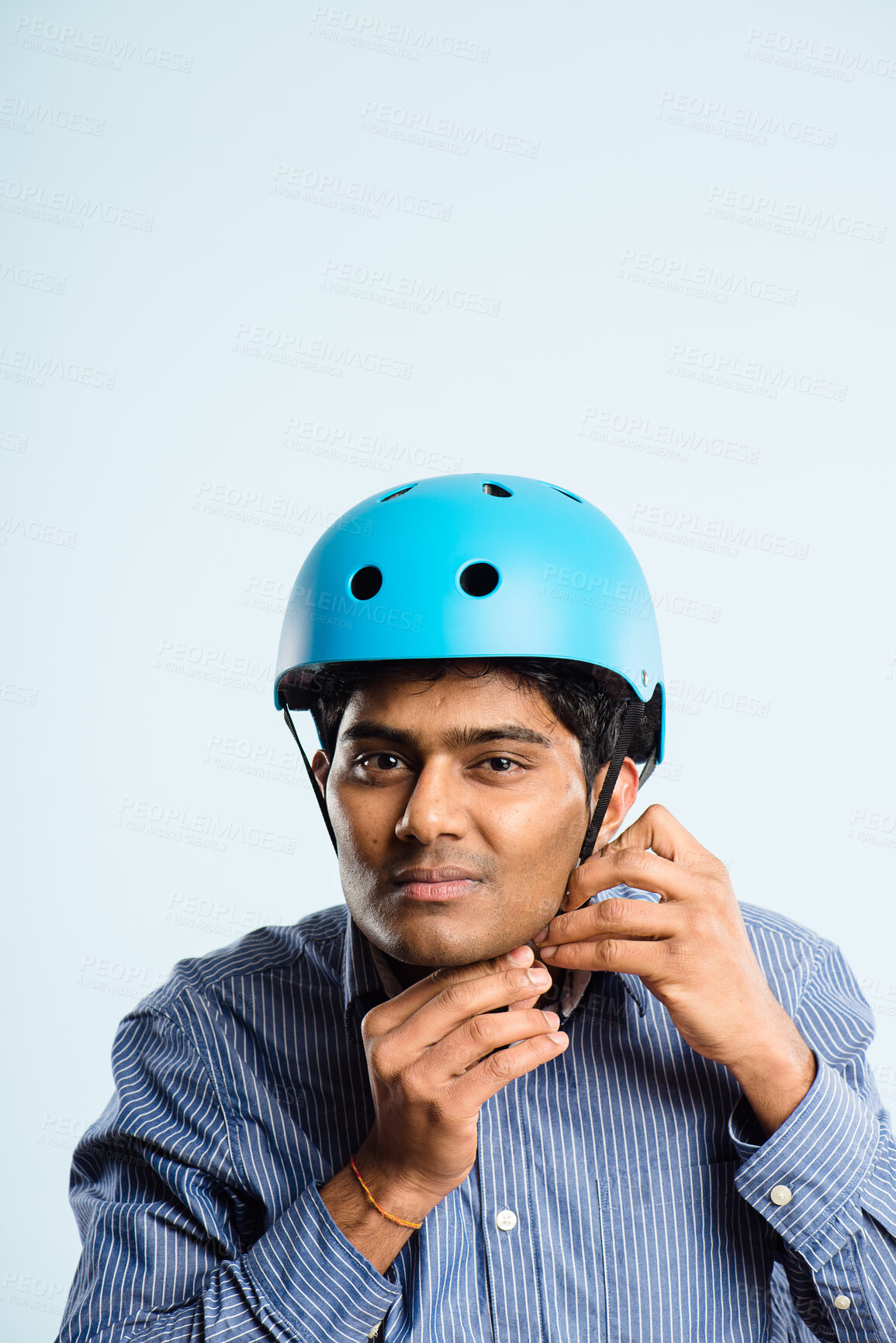 Buy stock photo Businessman, bicycle helmet and studio portrait with mockup space for safety by blue background. Person, hardhat and ready for eco friendly transportation for journey, travel or ride to job in India