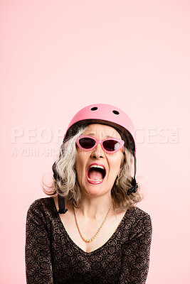 Buy stock photo Helmet, screaming and sunglasses of senior woman in studio isolated on pink background for cycling. Eyewear, safety and shouting with excited old person on mockup space for fashion, fitness or health