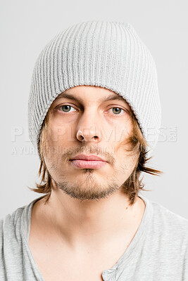 Buy stock photo Portrait, man and serious with beanie for fashion in studio, winter weather and warm clothes on cold morning. Pensive, male person and knitted hat for stylish aesthetic, trendy and white  background