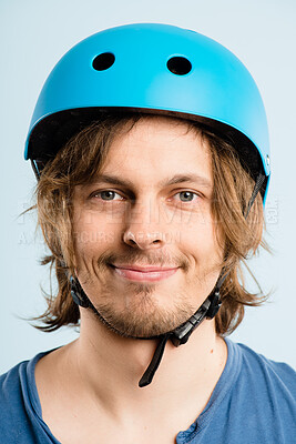 Buy stock photo Man, bike helmet and studio portrait with smile, pride and safety for trip by blue background. Person, hardhat and happy for eco friendly transportation for journey, travel and cycling in Germany