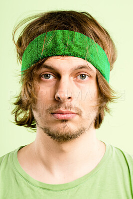 Buy stock photo Bored, fitness and portrait of man with headband, retro fashion and workout coach for gym in studio. Pride, face and male person with vintage style, exercise or serious on green background in Ireland