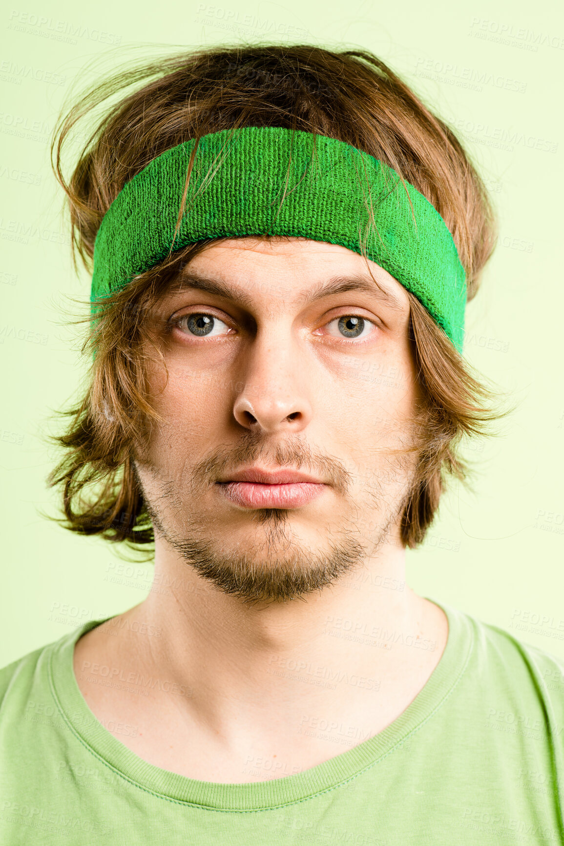 Buy stock photo Bored, fitness and portrait of man with headband, retro fashion and workout coach for gym in studio. Pride, face and male person with vintage style, exercise or serious on green background in Ireland