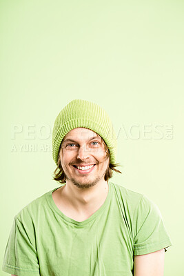 Buy stock photo Laugh, hat and portrait of man on green background with stylish, trendy accessory and cool clothes. Happy, smile and face of isolated person with beanie in studio for confidence, pride and fashion