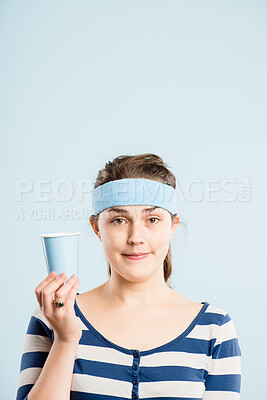 Buy stock photo Portrait, woman and headband for fashion in studio with retro fitness, coffee cup and gym workout of vintage style. Bored, female person and drinking tea, exercise break and mockup on blue background