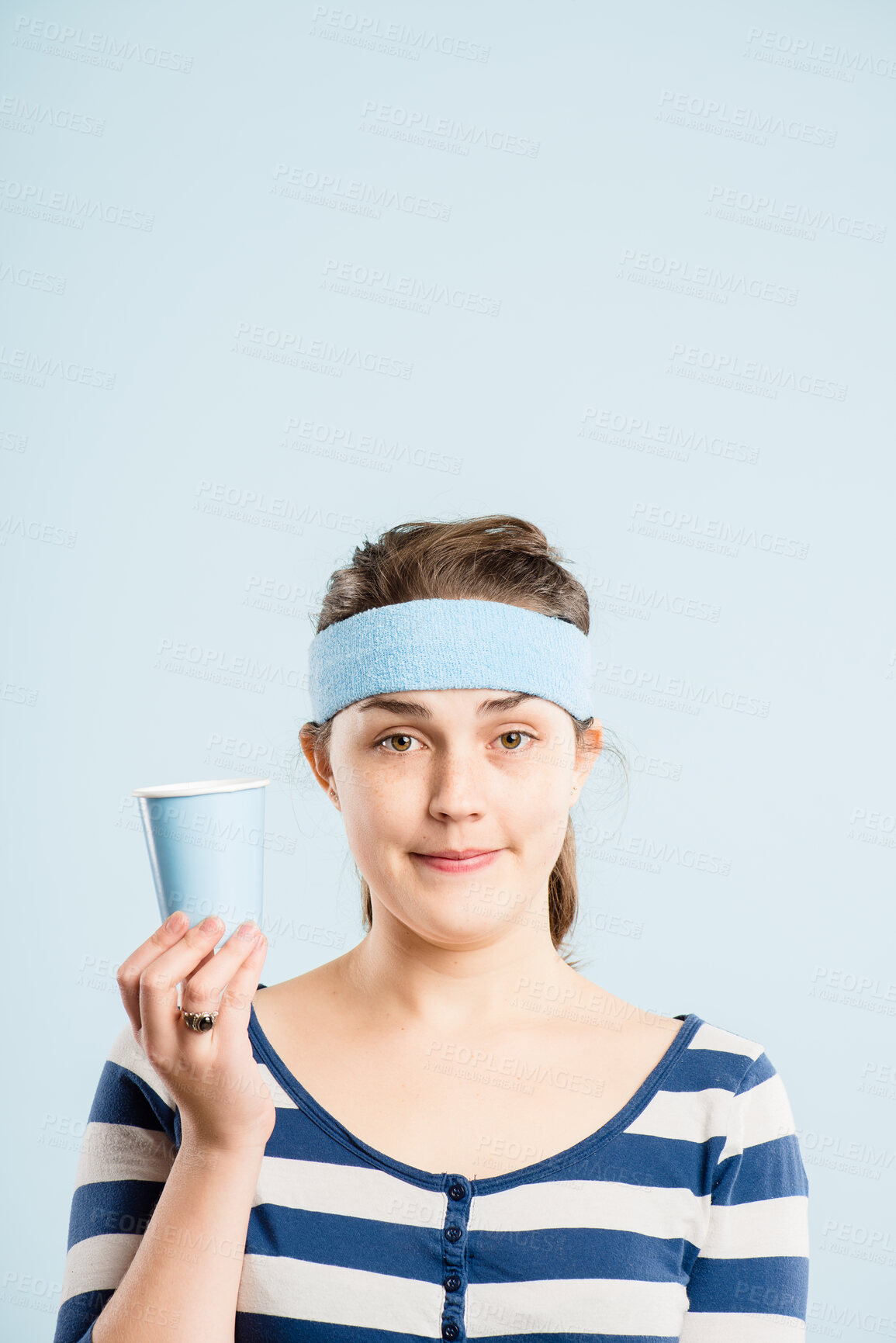 Buy stock photo Portrait, woman and headband for fashion in studio with retro fitness, coffee cup and gym workout of vintage style. Bored, female person and drinking tea, exercise break and mockup on blue background