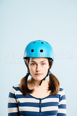 Buy stock photo Woman, bicycle helmet and studio portrait for safety, gear and trip with mockup space by blue background. Person, girl and ready with hardhat for eco friendly transport, journey and cycling in Greece